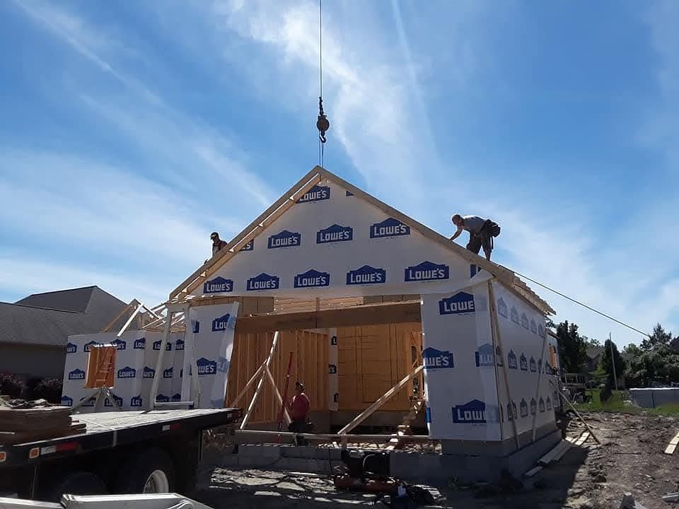Garage framing with gable-end roof trusses and crane