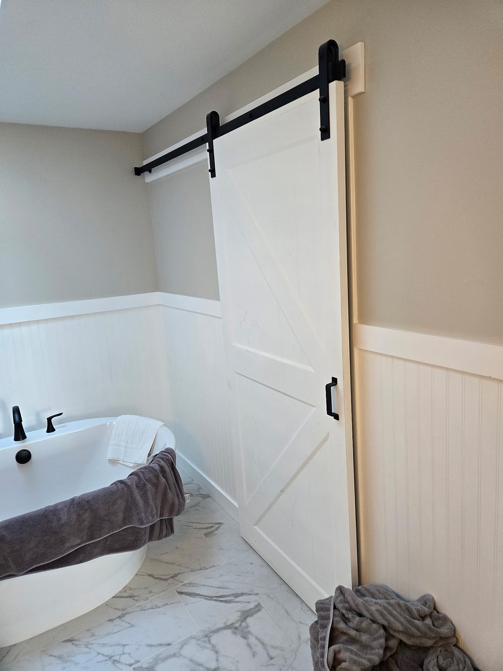 Bathroom remodel with mirrors and barn doors