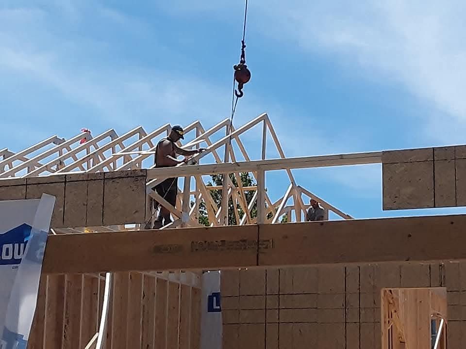 Sasquatch King crew installing roof trusses on a new home build